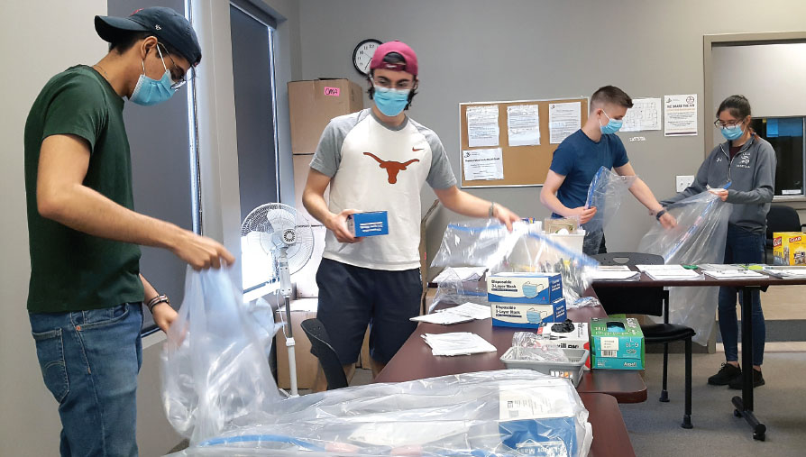 Medical and dental students prepare PPE physician packages at a London PPE drive. 