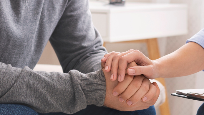 doctor holding hands with a patient