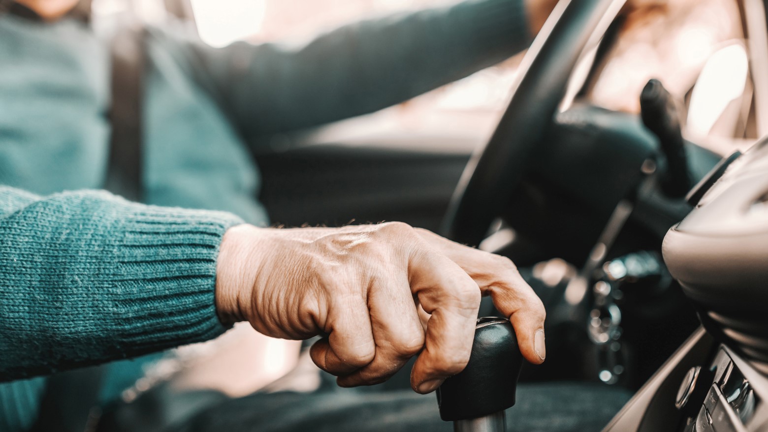 older person driving with a gear shift
