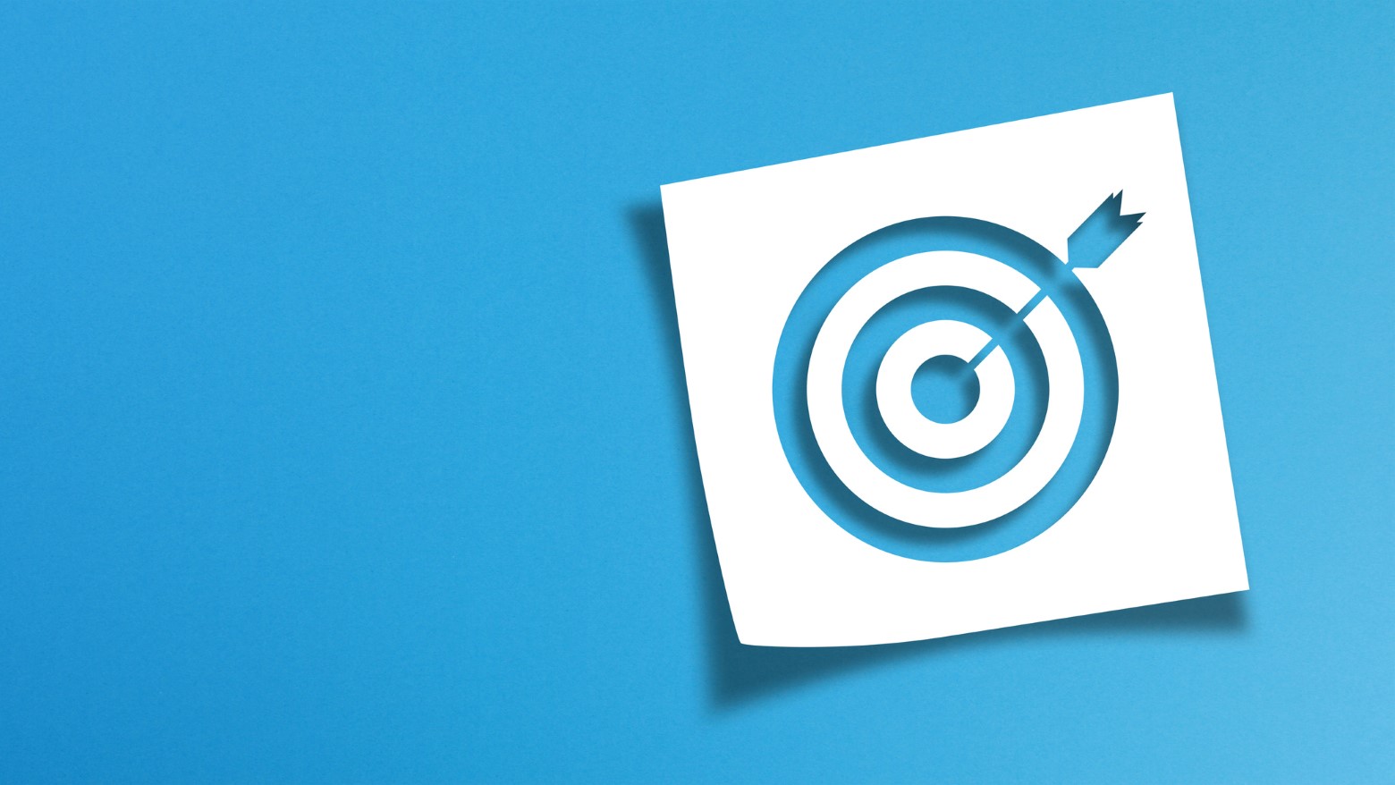 A white bullseye target graphic with an arrow, set against a solid blue background, symbolizing focus and goal achievement.