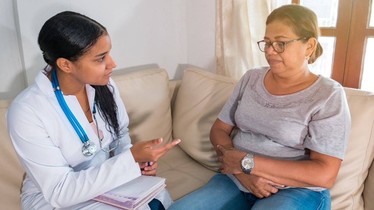 Doctor sitting down talking to a patient