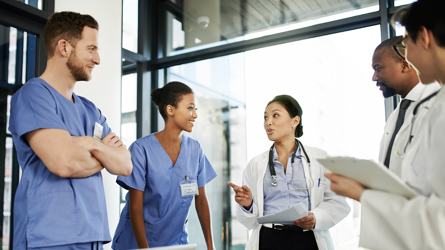 A group of doctors speak in a meeting room