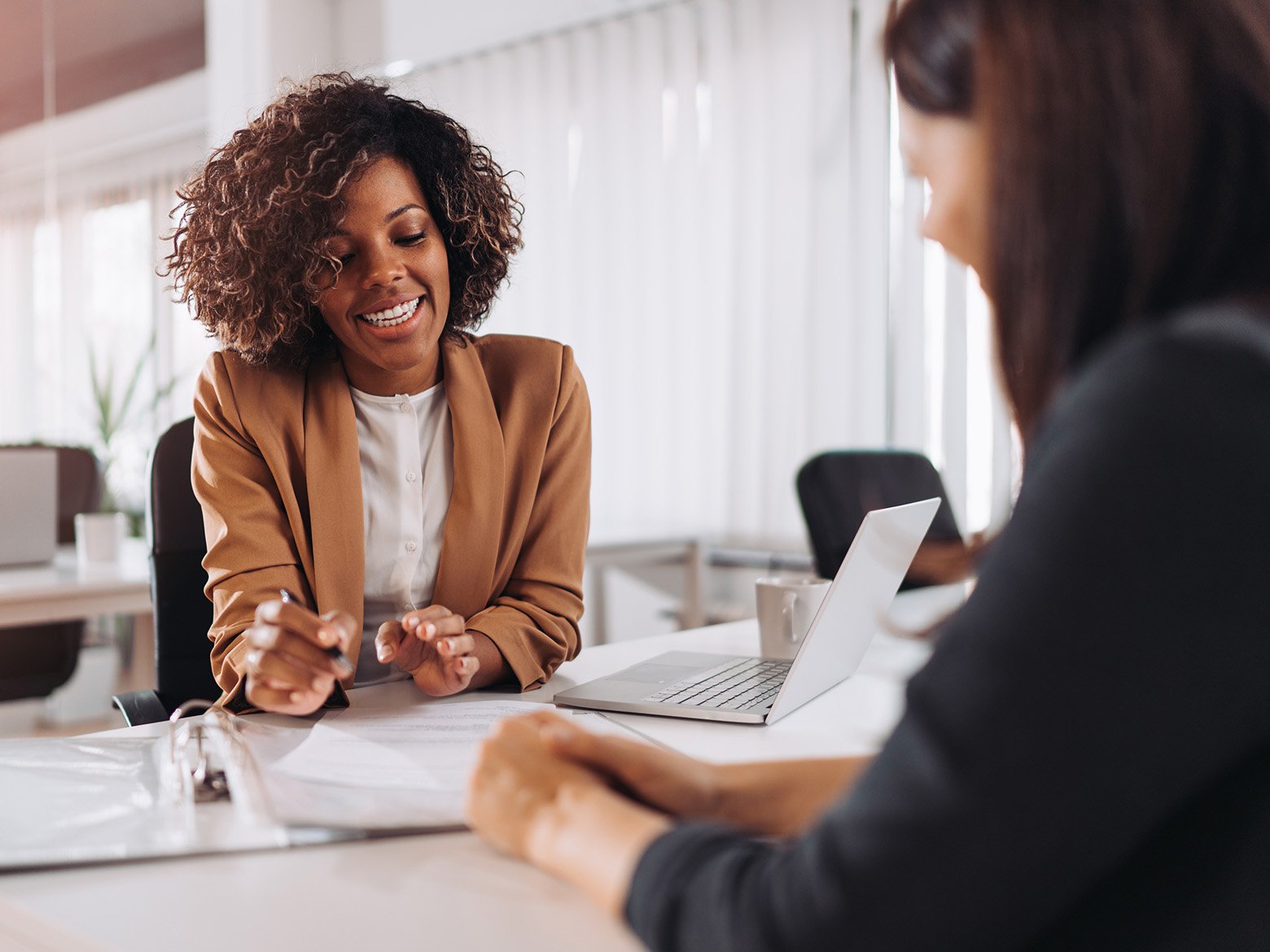A woman discusses paperwork with an advisor