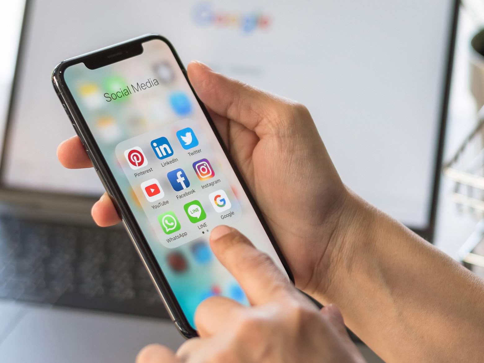 Someone uses an iPhone to look at their social media apps