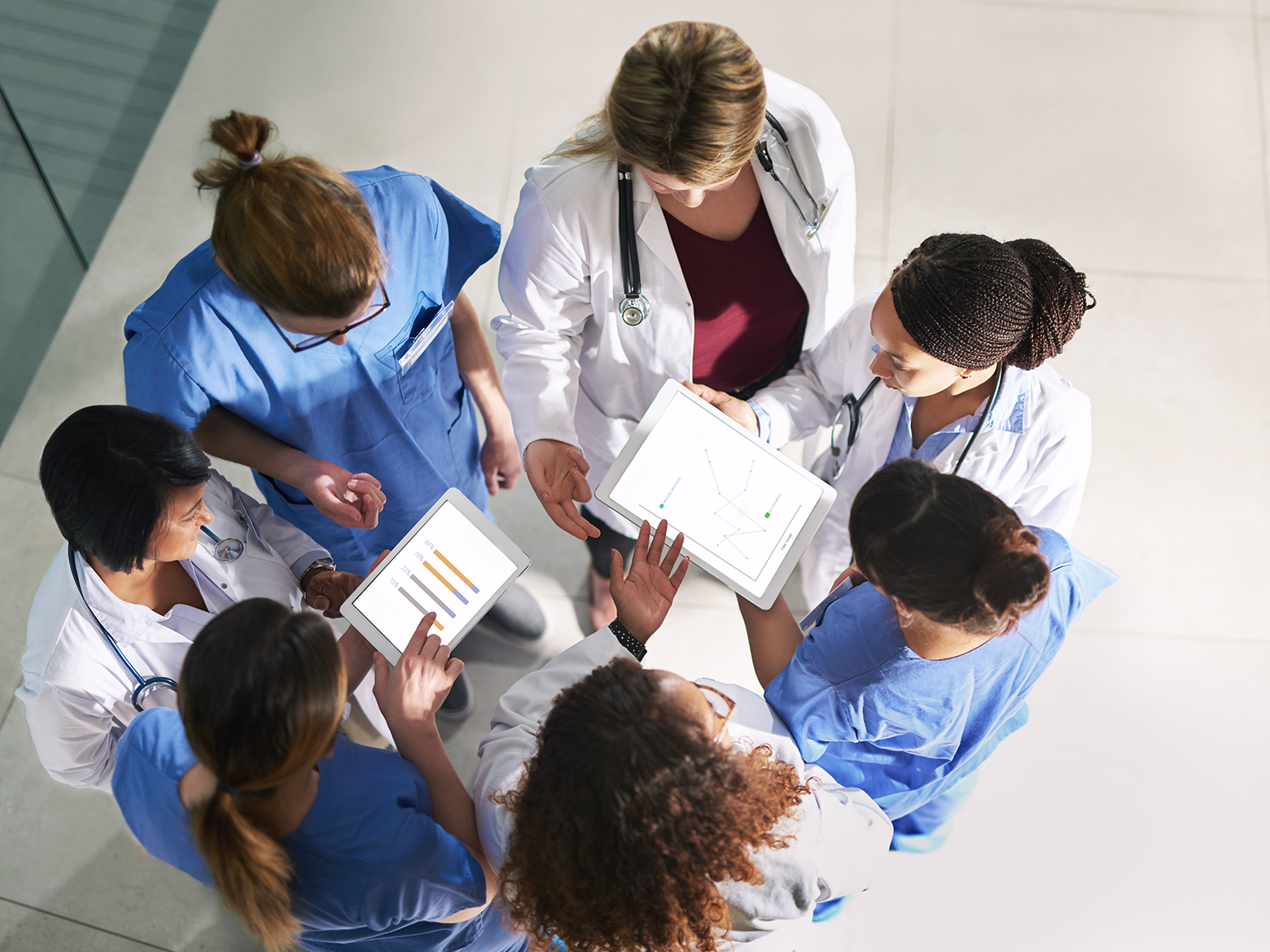 A group of doctors huddle to discuss paperwork