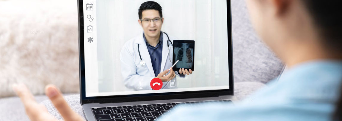 A doctor provides virtual care to a patient via video call on a laptop