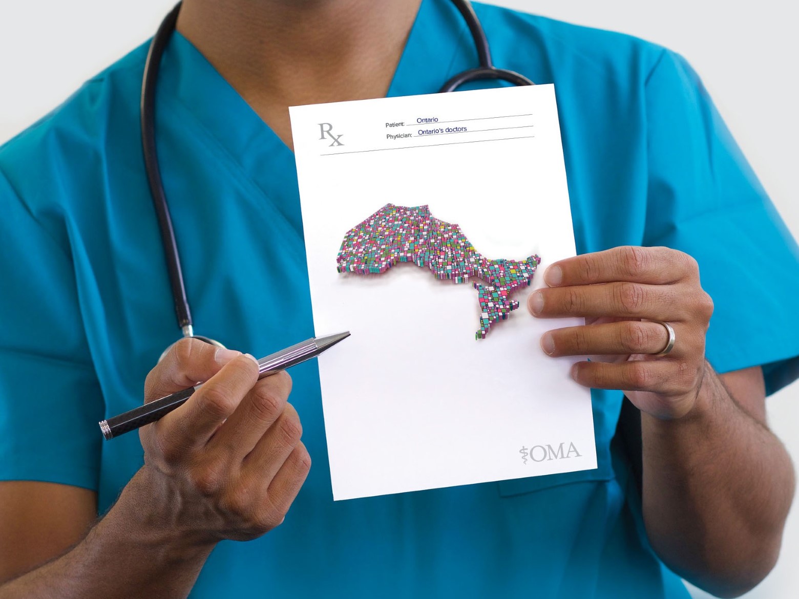 Physician holding a graphic of the province of Ontario