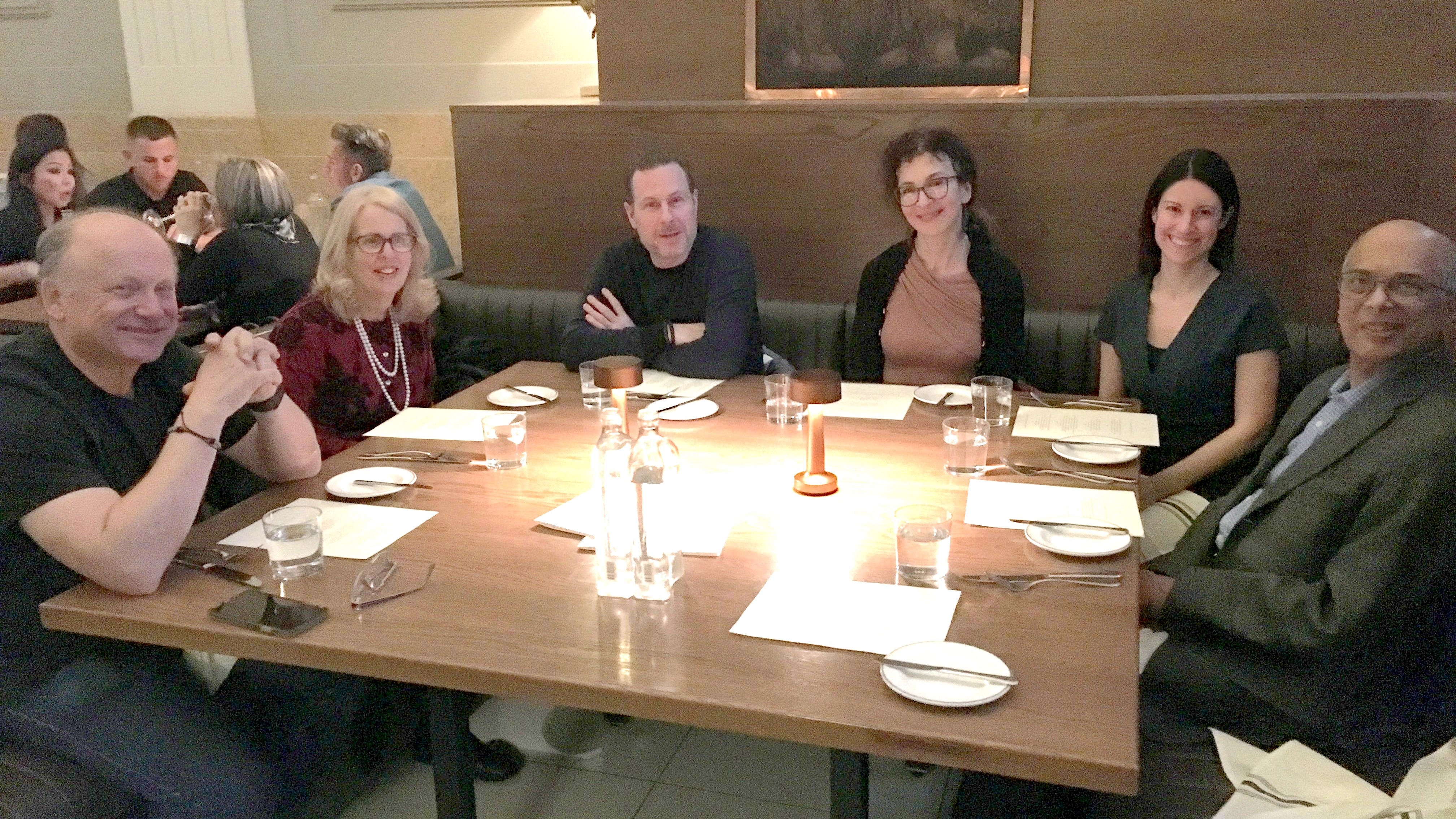 group of doctors sitting around a table at a spring council meeting