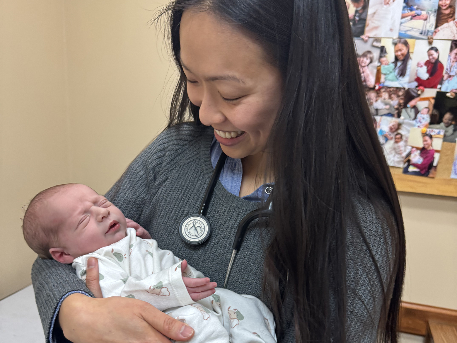 A picture of Dr. Elizabeth Liao holding a newborn baby.