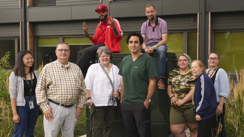 r. Andrew Boozary stands with colleagues and tenants outside of Dunn House in Toronto.