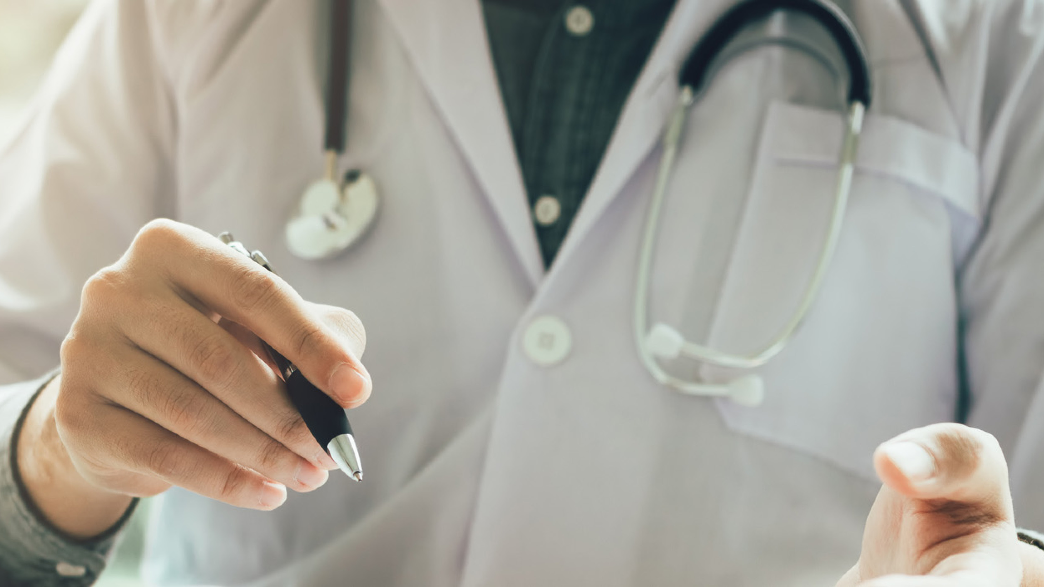 Physician holding a pen  