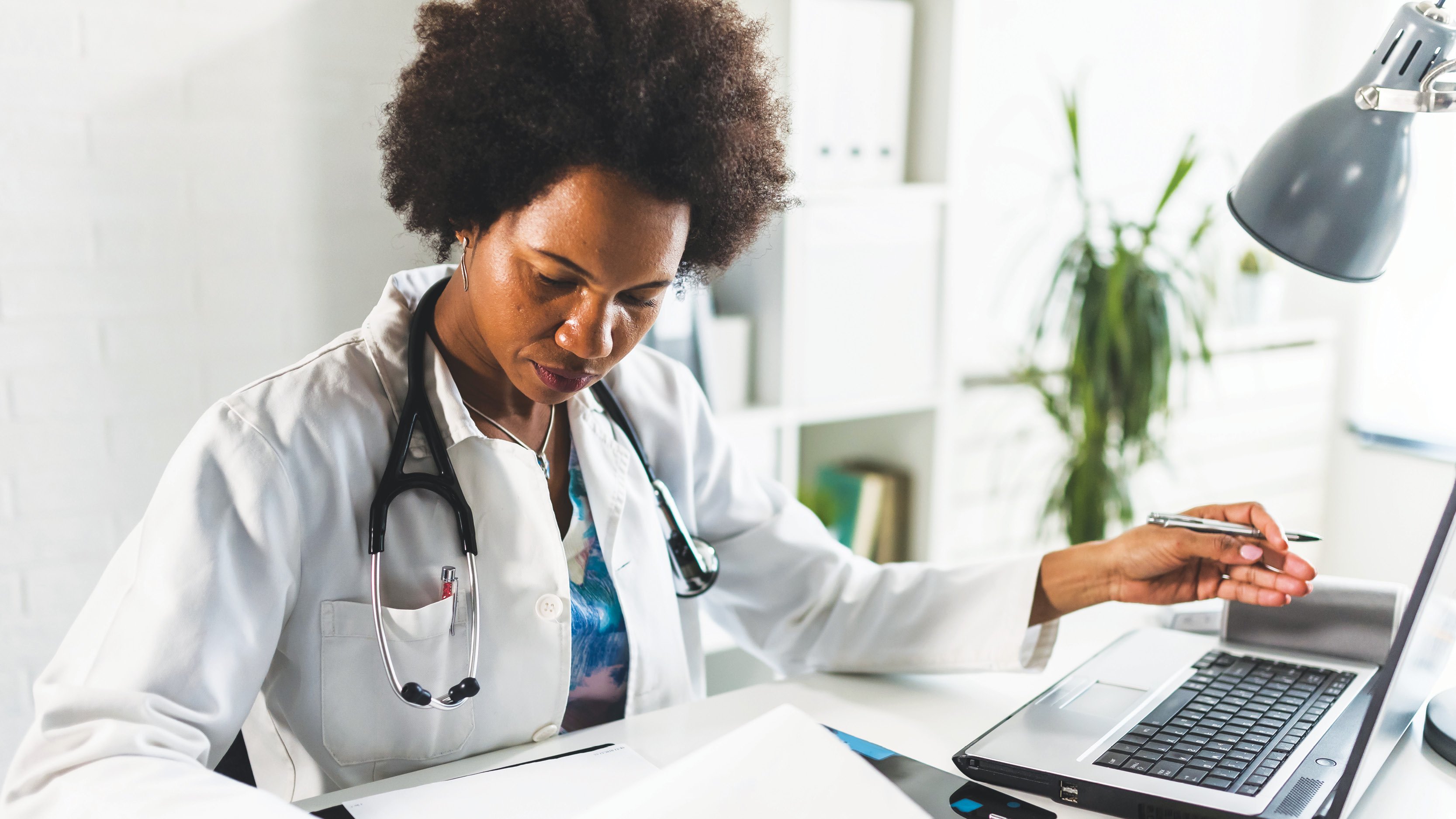 Female physician working at a computer