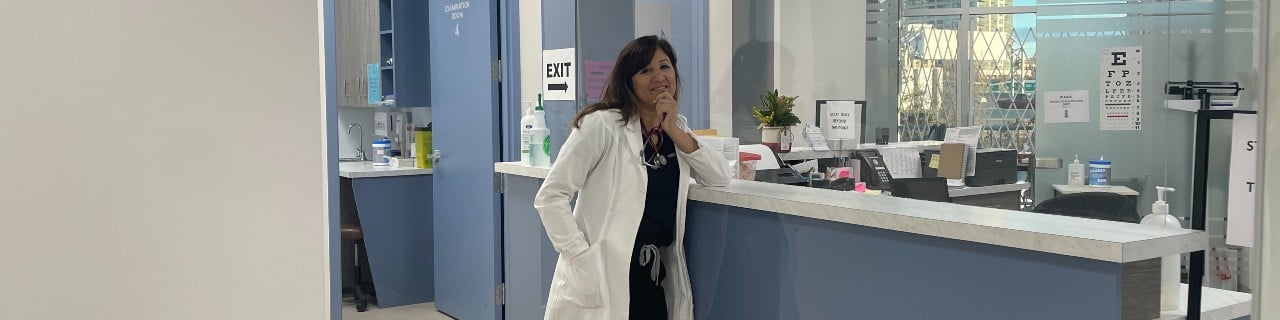 Dr. Lubna Tirmizi at a reception desk at a hospital