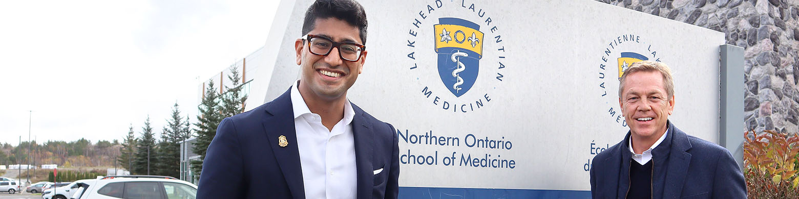 Dr Adam Kassam and Allen O'Dette stand outside of the Northern Ontario School of Medicine
